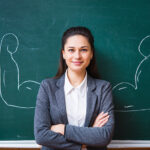 smiling young teacher near the board